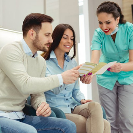 Dental team member helping family navigate their Aetna dental insurance plan