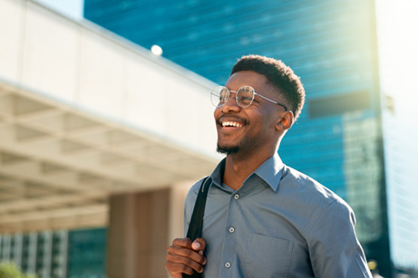 Man in business attire smiling in the sun
