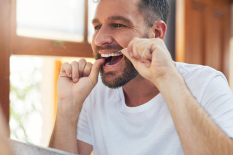 Man flossing his teeth