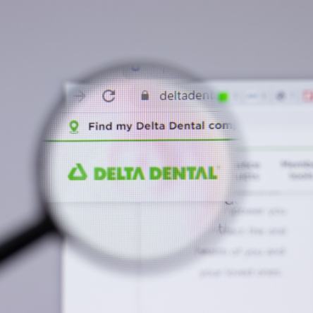 Magnifying glass showing Delta Dental logo on website