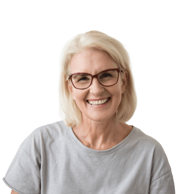 Woman in grey shirt smiling with implant dentures in Mesquite