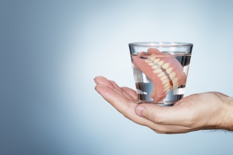 Holding dentures in glass full of water