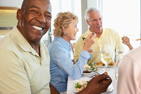 Dentures patient in Mesquite talking with friends