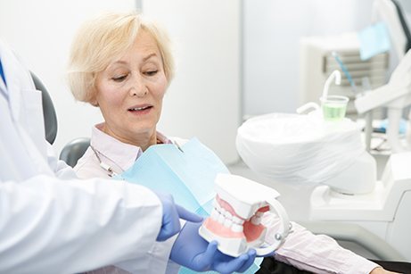 Dentures patient in Mesquite smiling with dentist