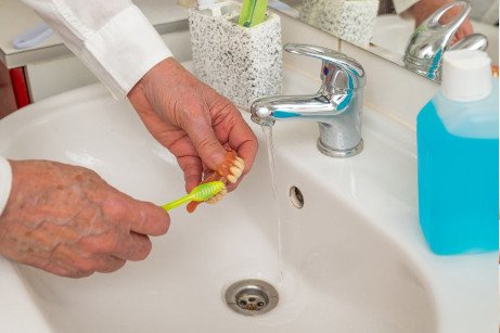 Dentures being brushed