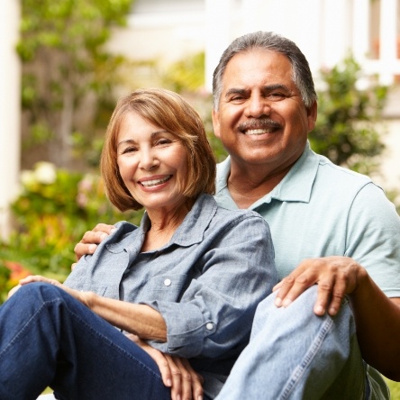 Man and woman sitting outside and smiling