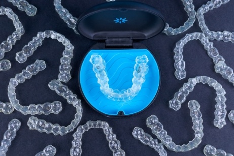 Invisalign aligner in case surrounded by other aligners