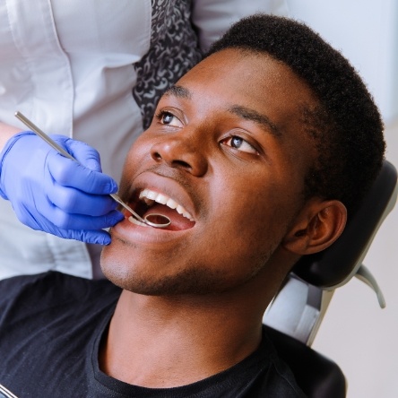 Man in dental chair receiving checkup for preventive dentistry in Mesquite